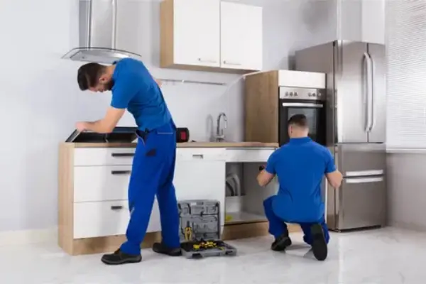 Technician repairing dishwasher